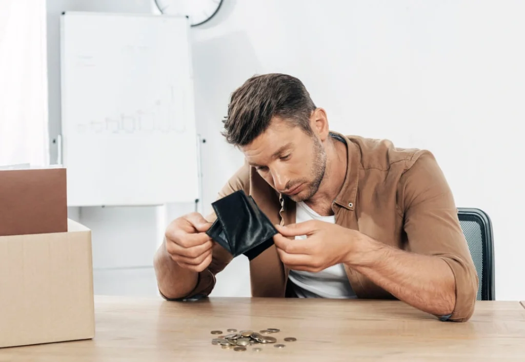 Man checking empty wallet while on the phone.
