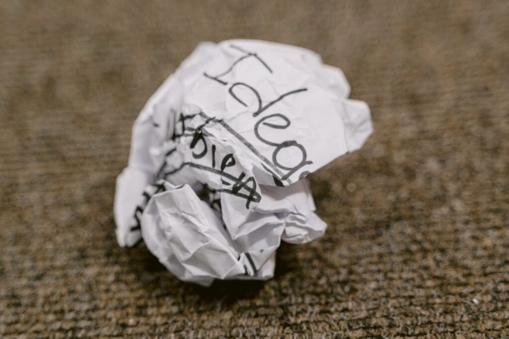 A crumpled paper with the word “Idea,” symbolising brainstorming challenges often faced before starting Android app development services in Malaysia.